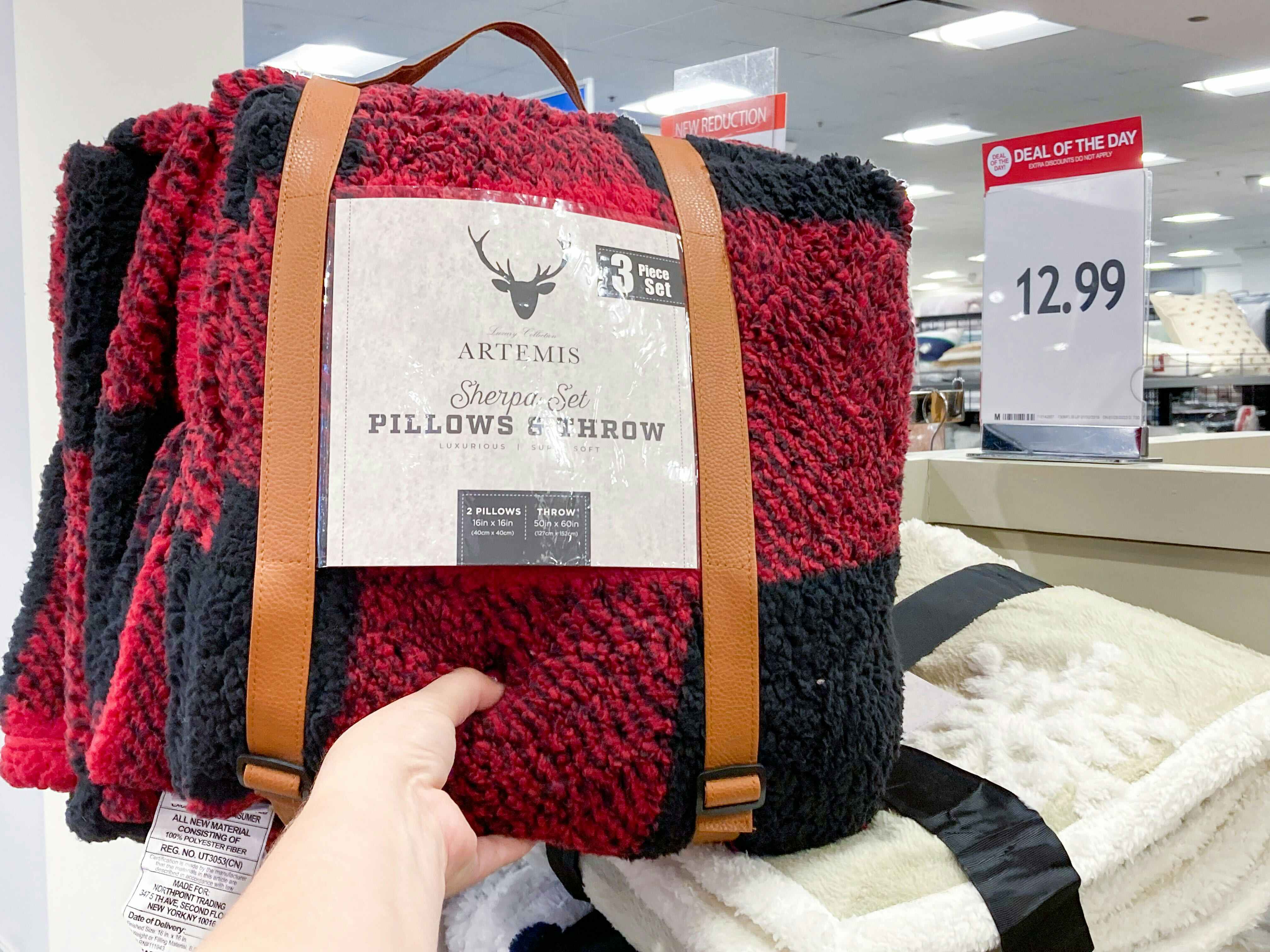 a throw blanket and pillow set in red and black plaid