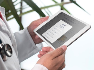 doctor verifying medical professional status on ipad for asics discount