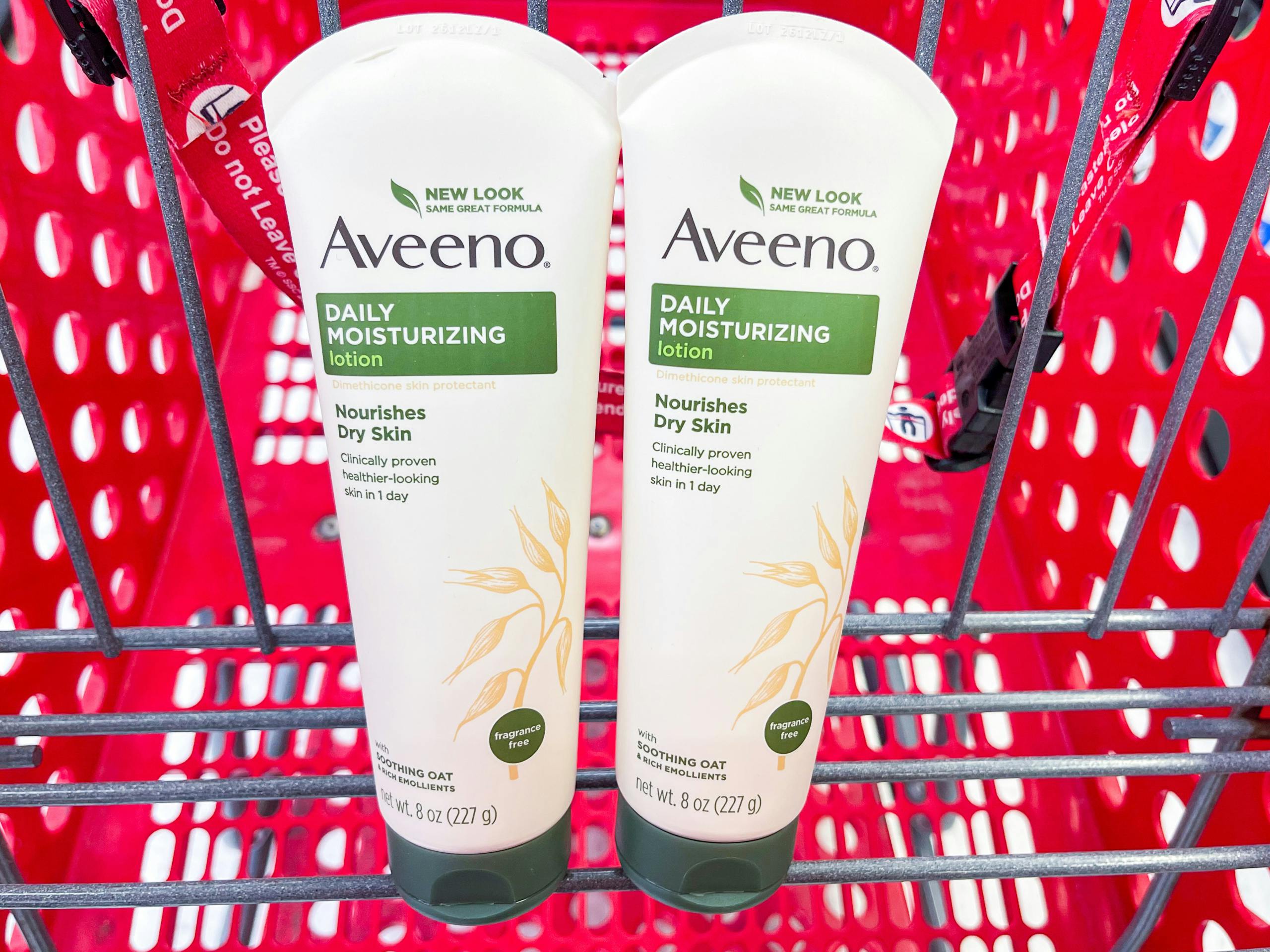 Two tubes of 8oz Aveeno Daily Moisturizing Lotions sitting in a store shopping cart.