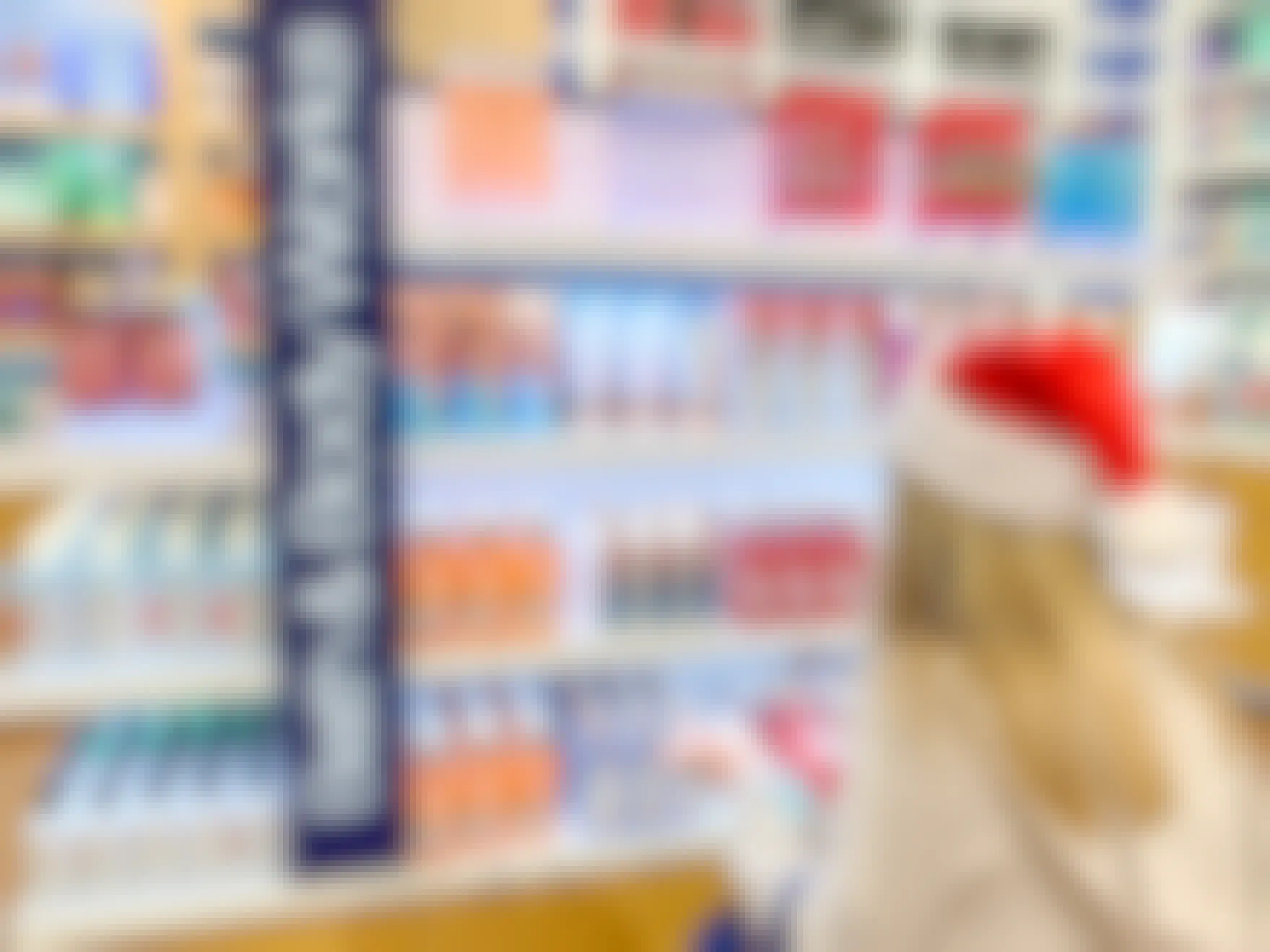 A woman in a santa hat looking at Body care items at bath and body works