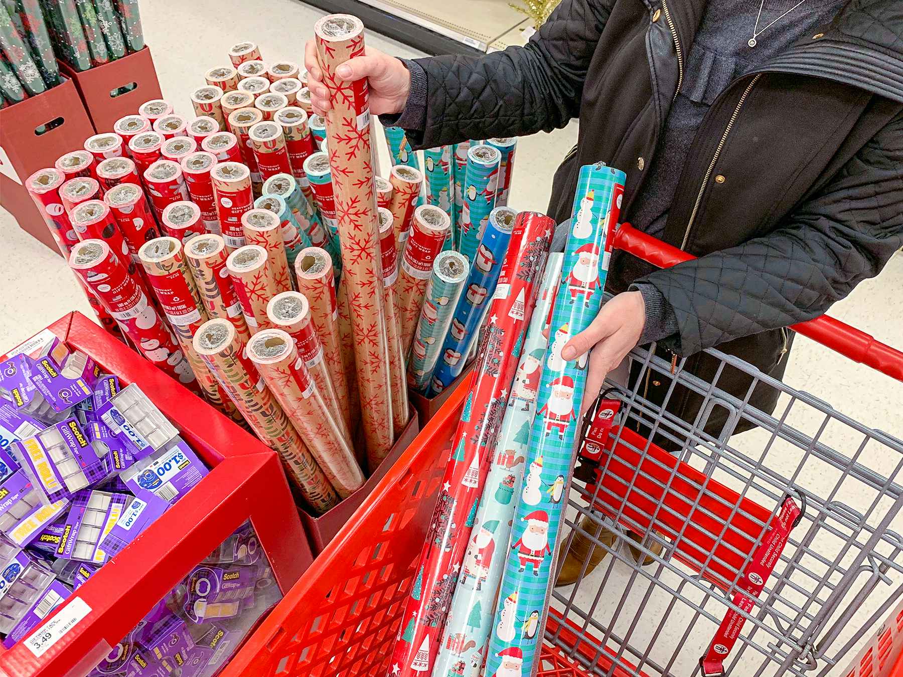 A person shopping for rolls of gift wrapping paper at Target