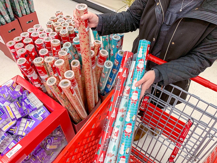 A person shopping for rolls of gift wrapping paper at Target