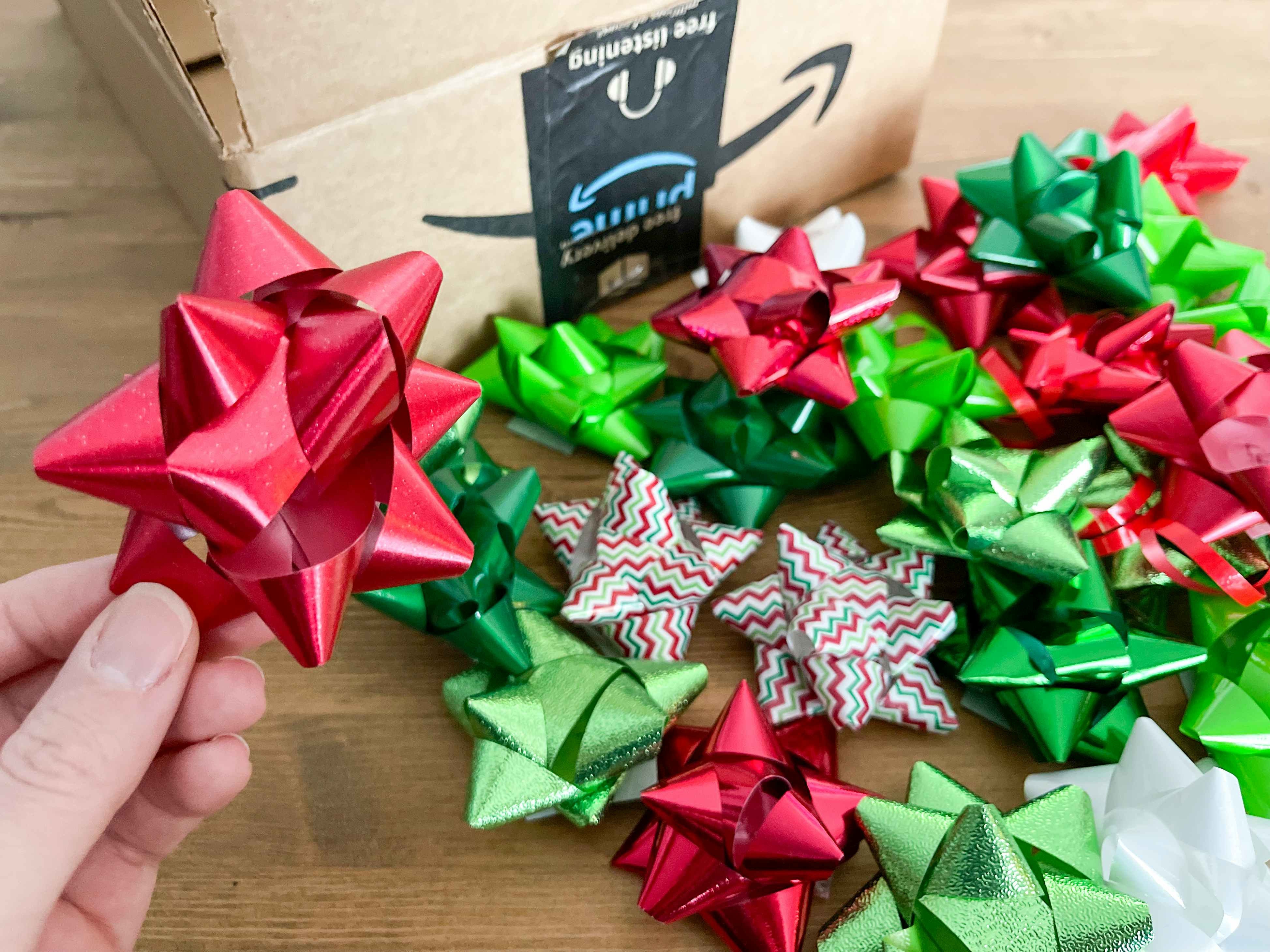 Christmas gift wrap bows next to an amazon box