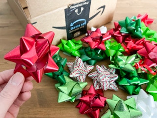 Christmas gift wrap bows next to an amazon box