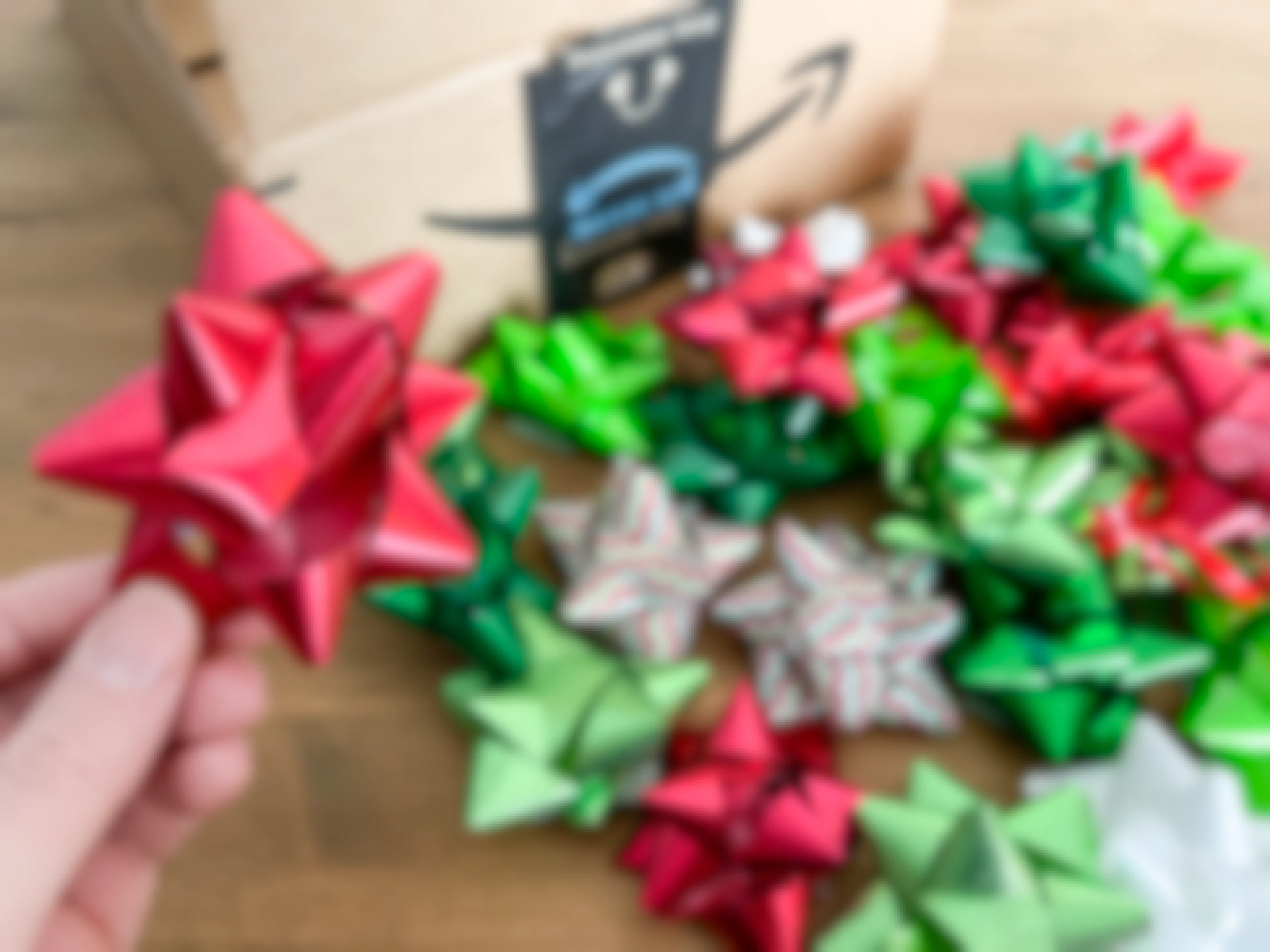Christmas gift wrap bows next to an amazon box