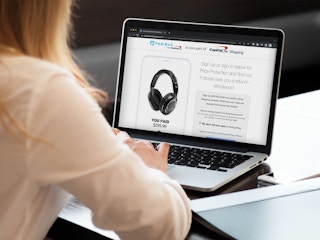 A person signing up for Capital One Shopping on a laptop