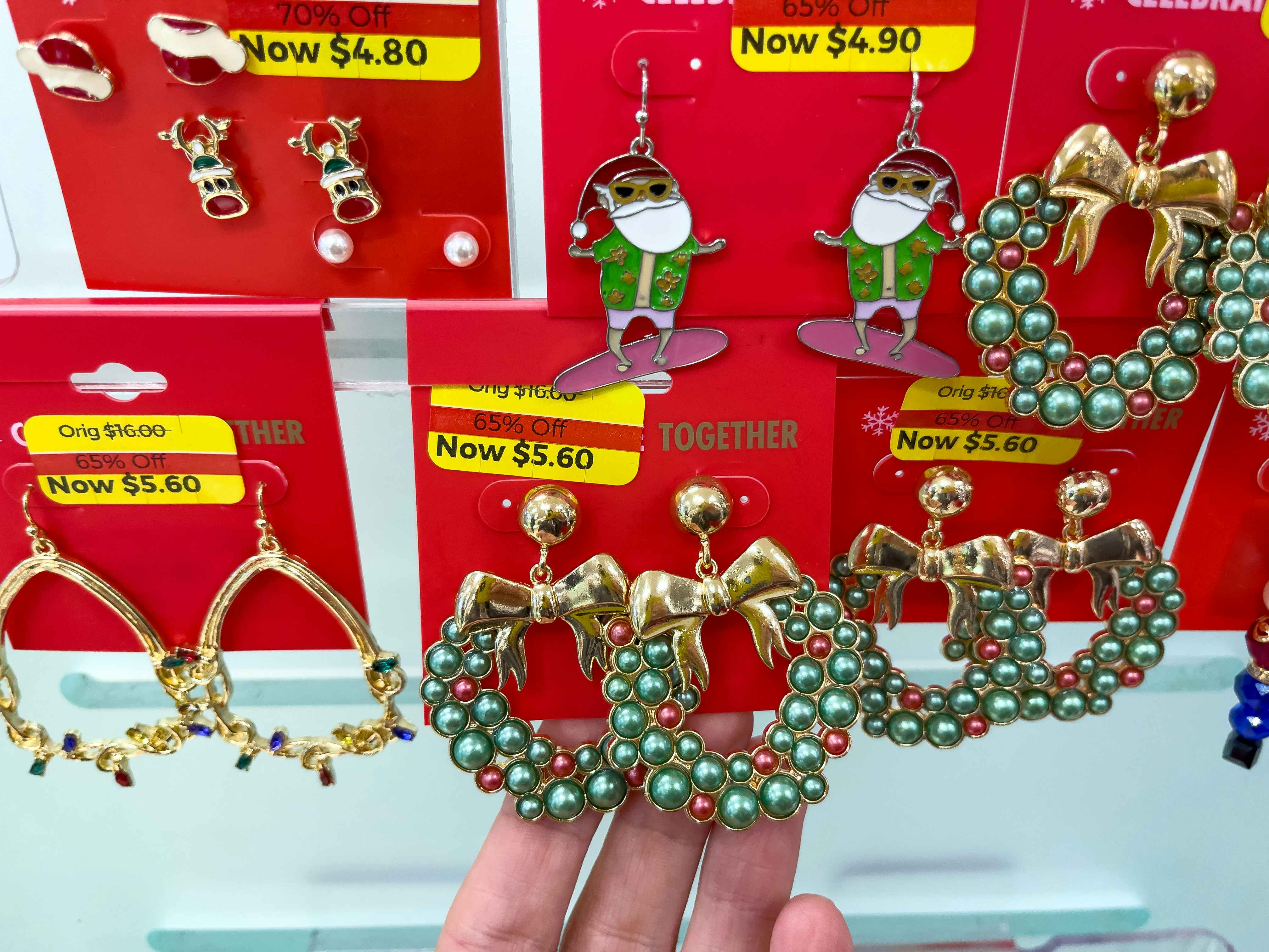 A variety of earrings hanging from a store rack