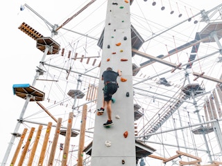 person at nona adventure climbing tower in orlando florida