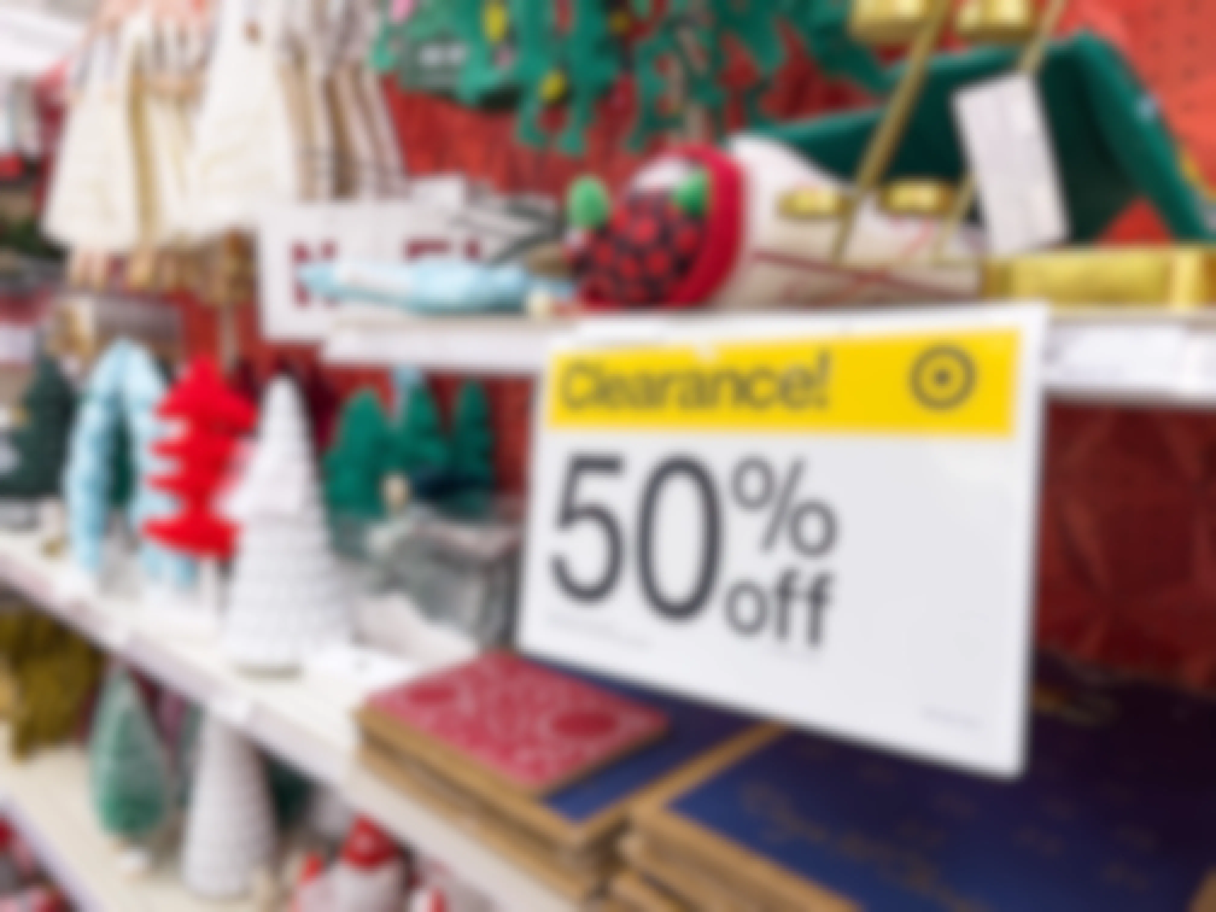 A 50% off clearance sign on a shelf of Christmas items at Target