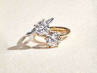 Two wedding rings against a textured background