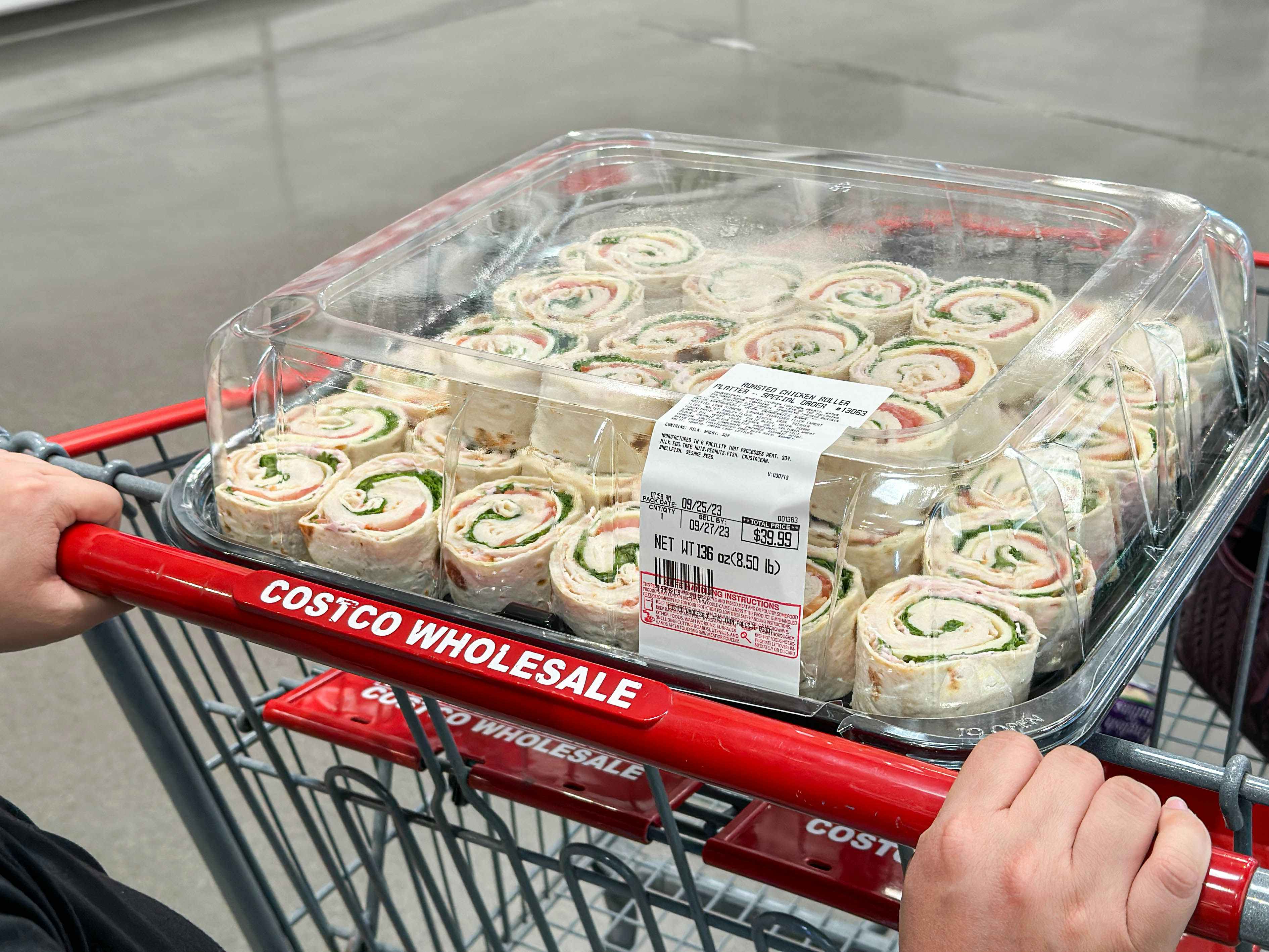 a costco catering platter being pushing in the basket of a costco cart