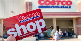 Costco Shop card held in front of Costco.