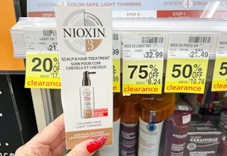 hand holding nioxin next to clearance tag