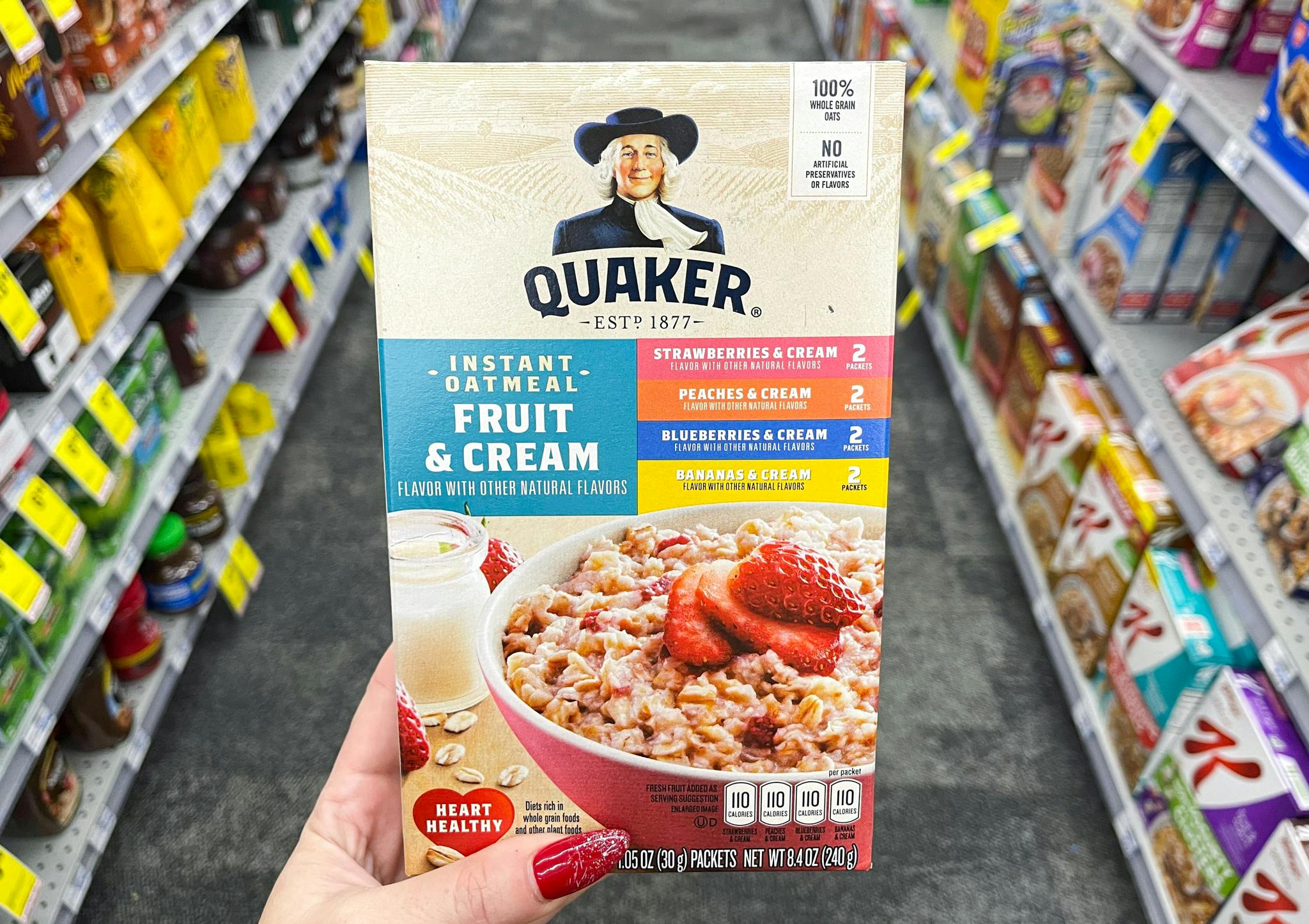 someone holding quaker instant oatmeal box in aisle