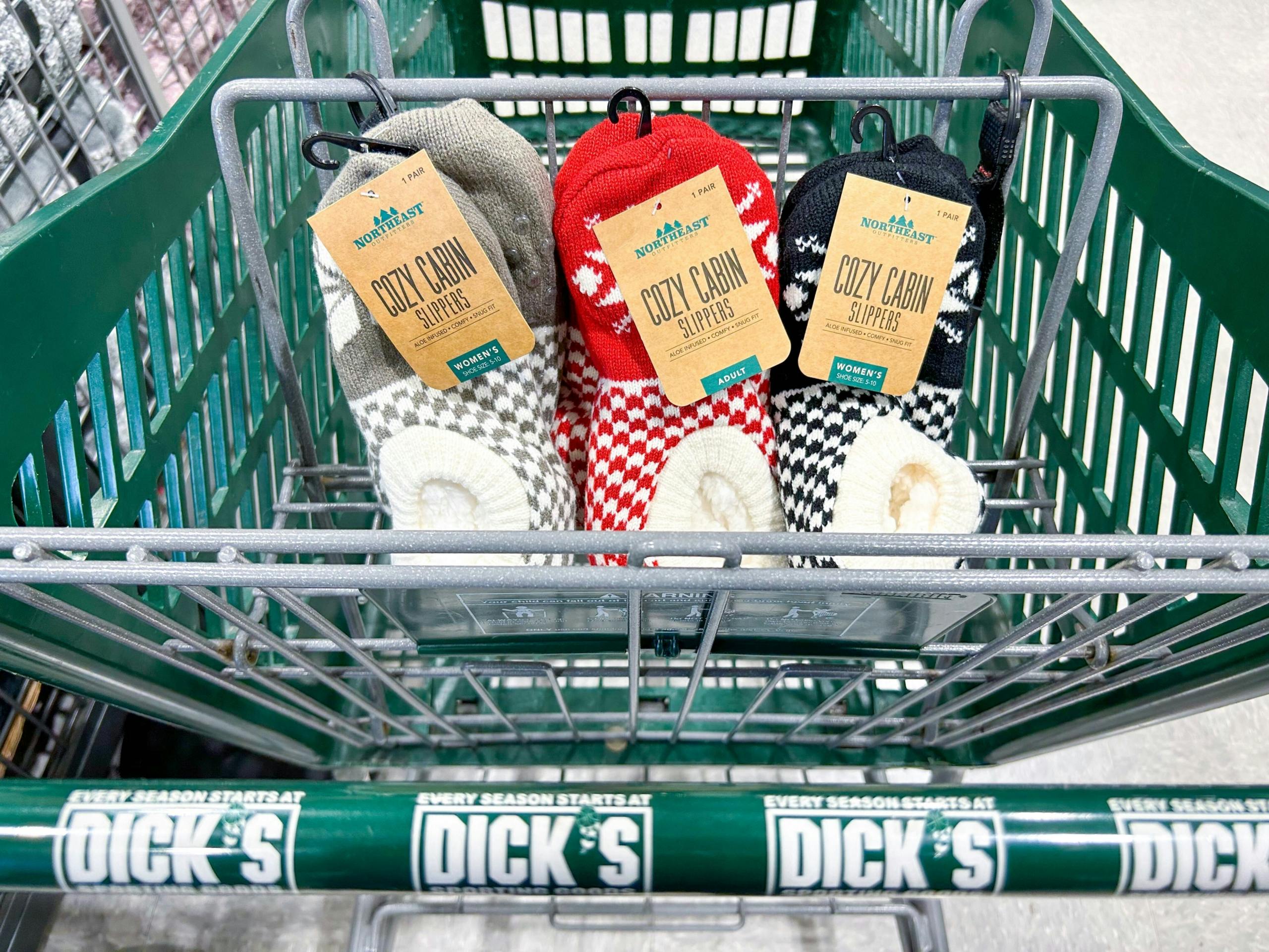 three pairs of fuzzy slipper socks in a green DSG shopping cart