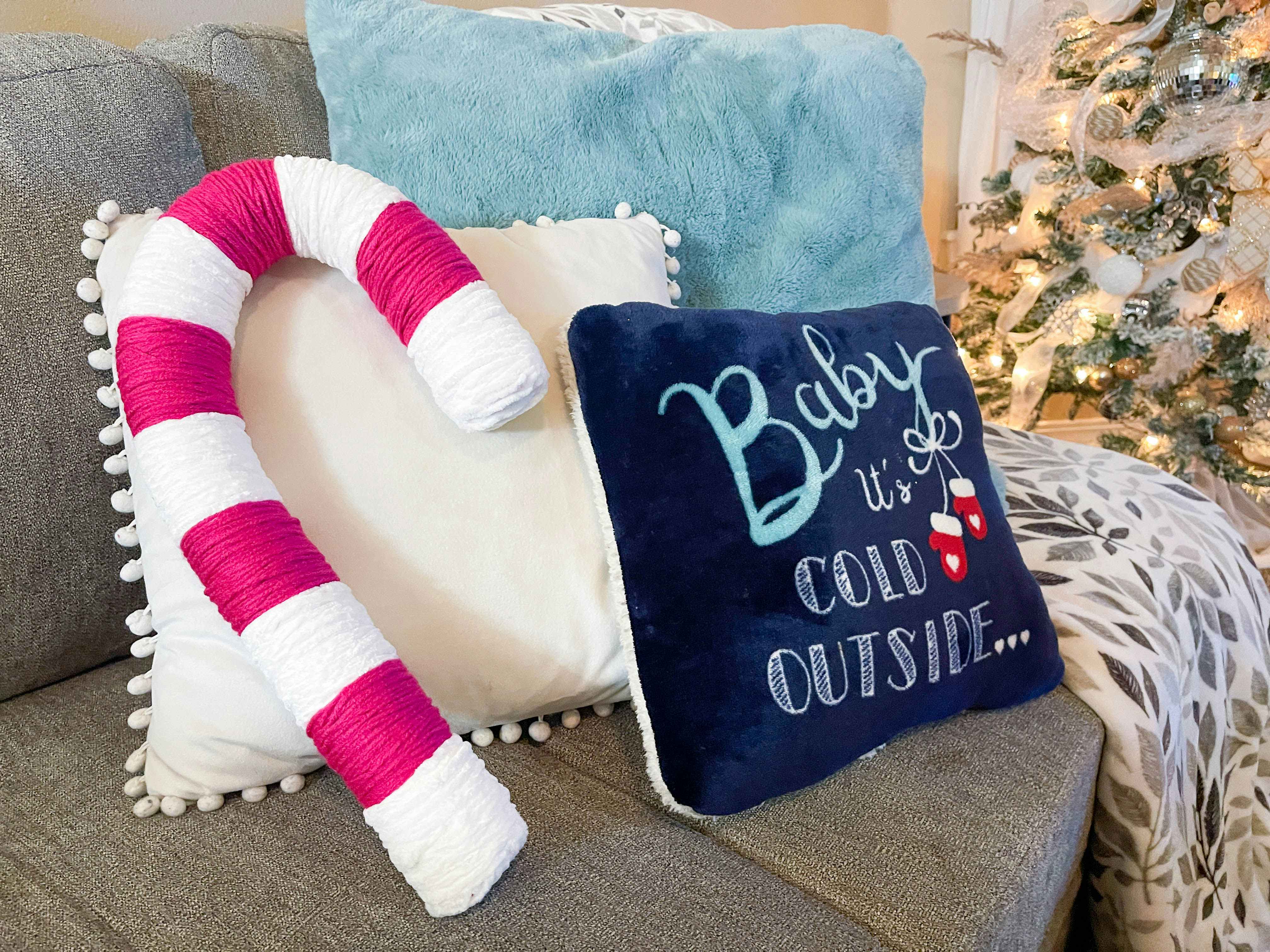 a candy cane pillow made with a pool noodle and pink and white yard 