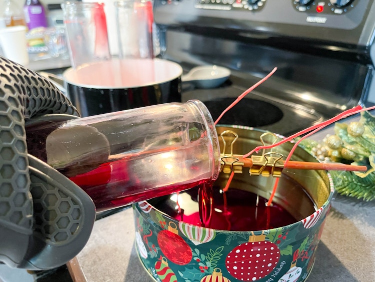 wax being pouring into christmas tin