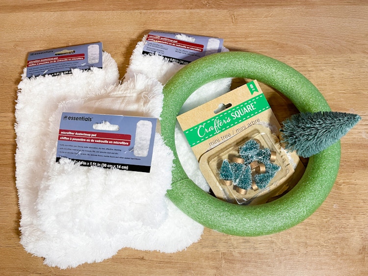 dollar tree mops, foam wreath form, mini bottle brush trees on a table 
