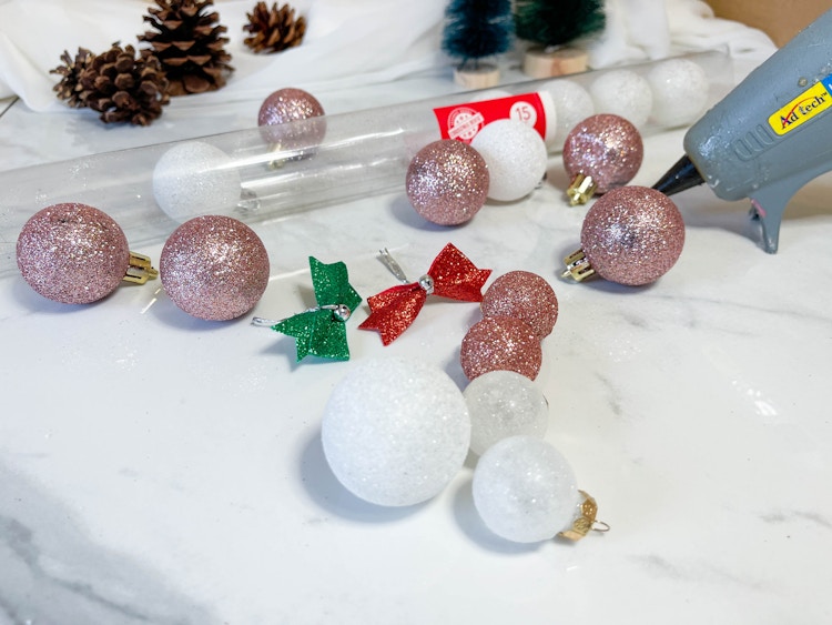 ornaments on a table next to a glue gun