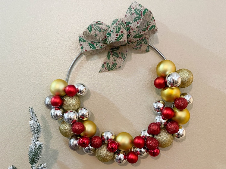a wreath made of ball ornaments 