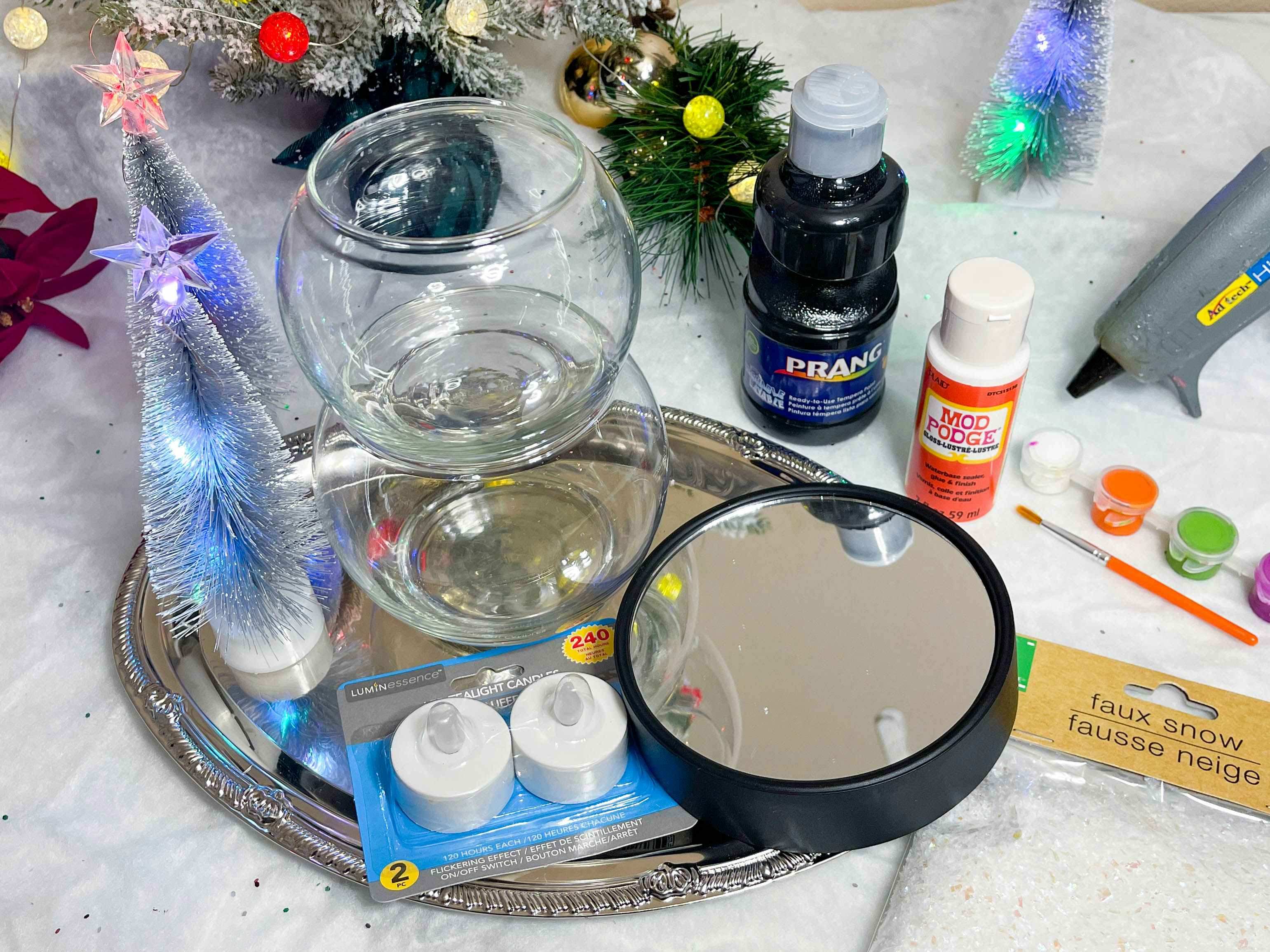 supplies to make a diy snowman candle holder on table