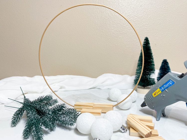 a glue gun with diy supplies for a diy christmas craft