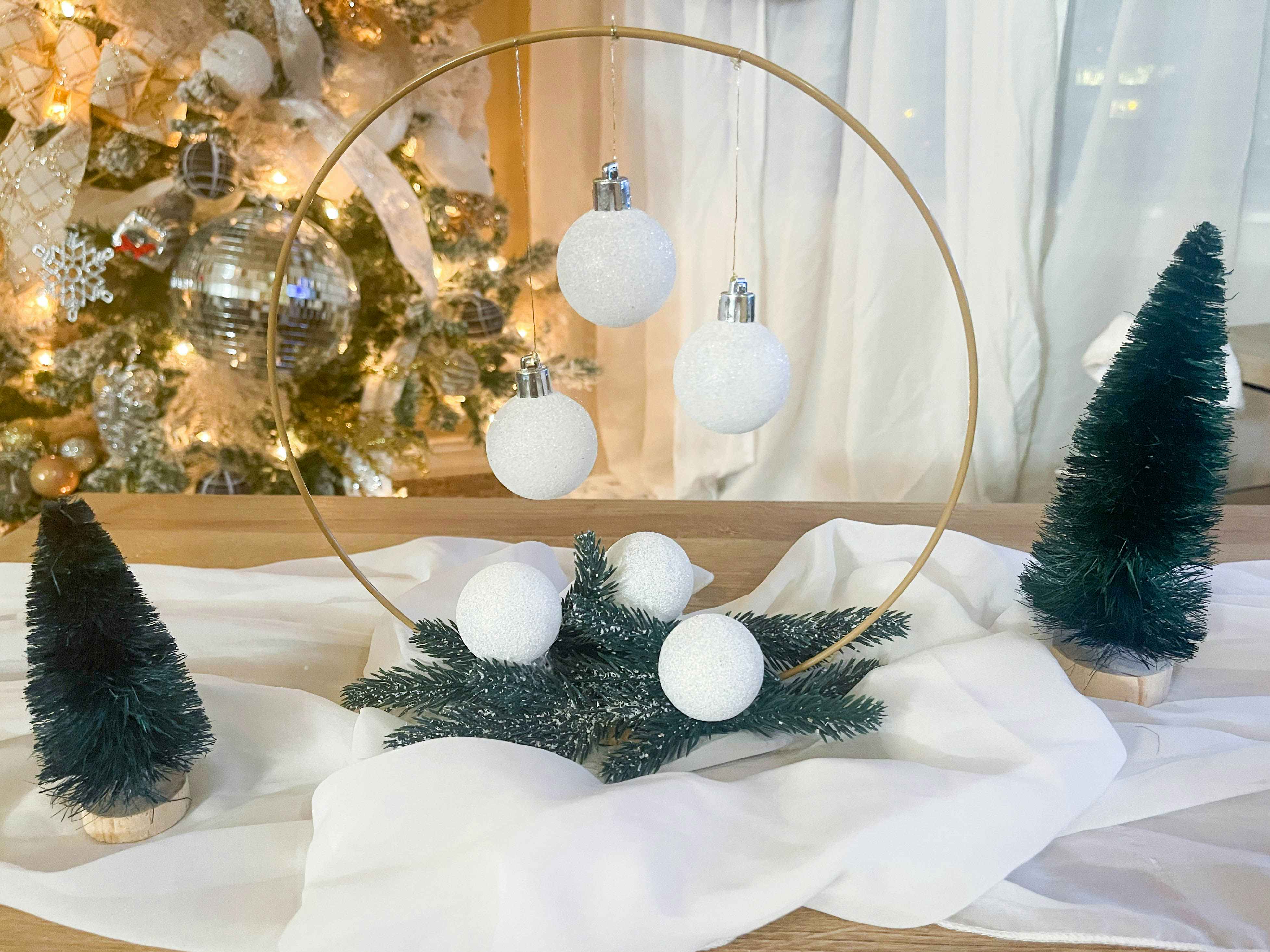 a diy christmas hoop wreath with hanging ornaments