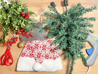 supplies to make a diy gnome wreath on a table 
