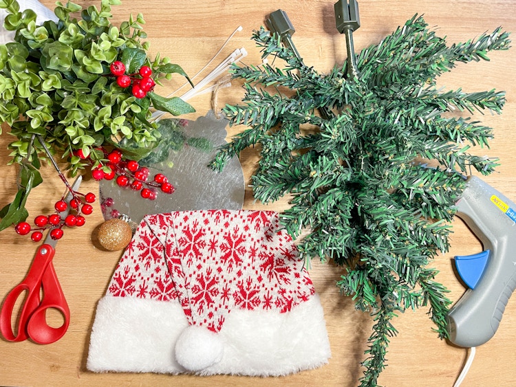 supplies to make a diy gnome wreath on a table 