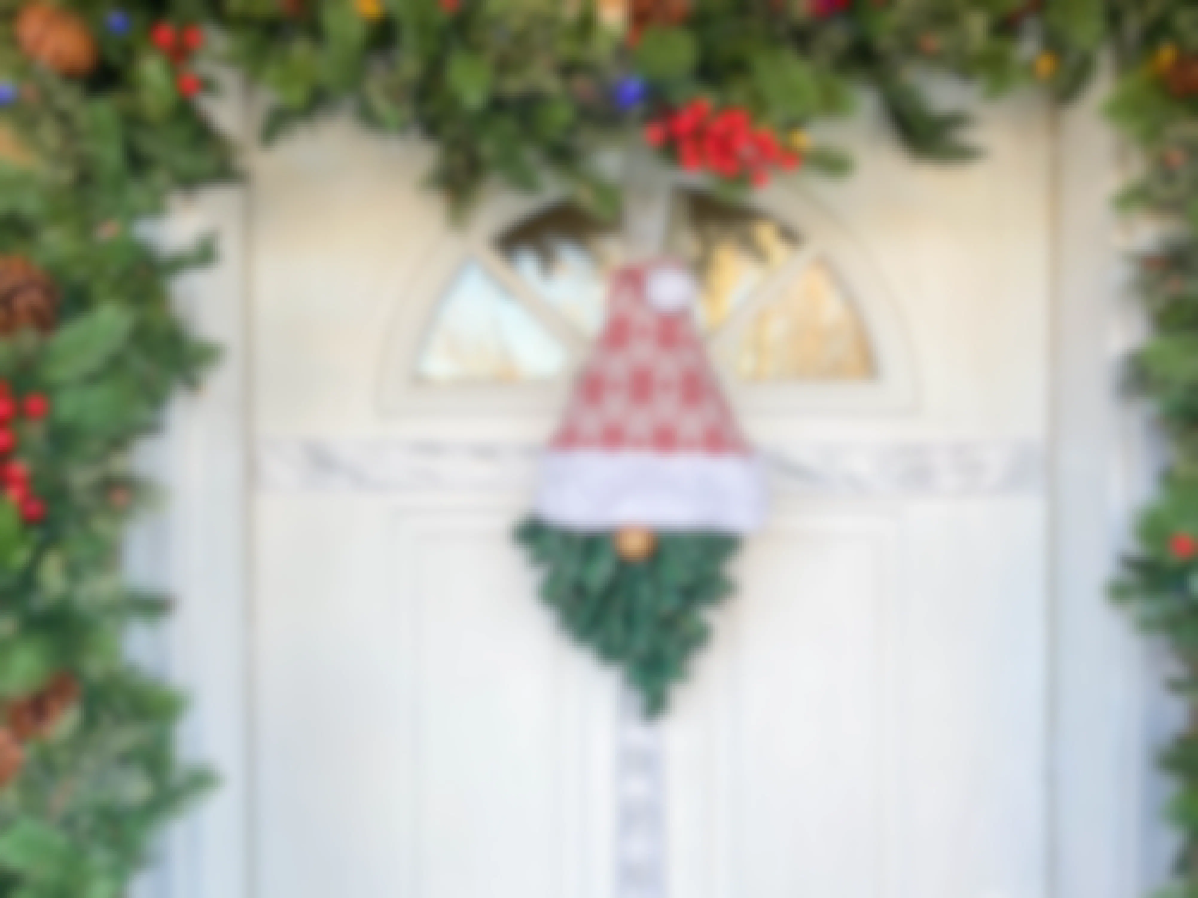 a gnome wreath hanging on a door