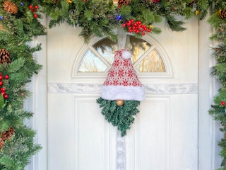 a gnome wreath hanging on a door