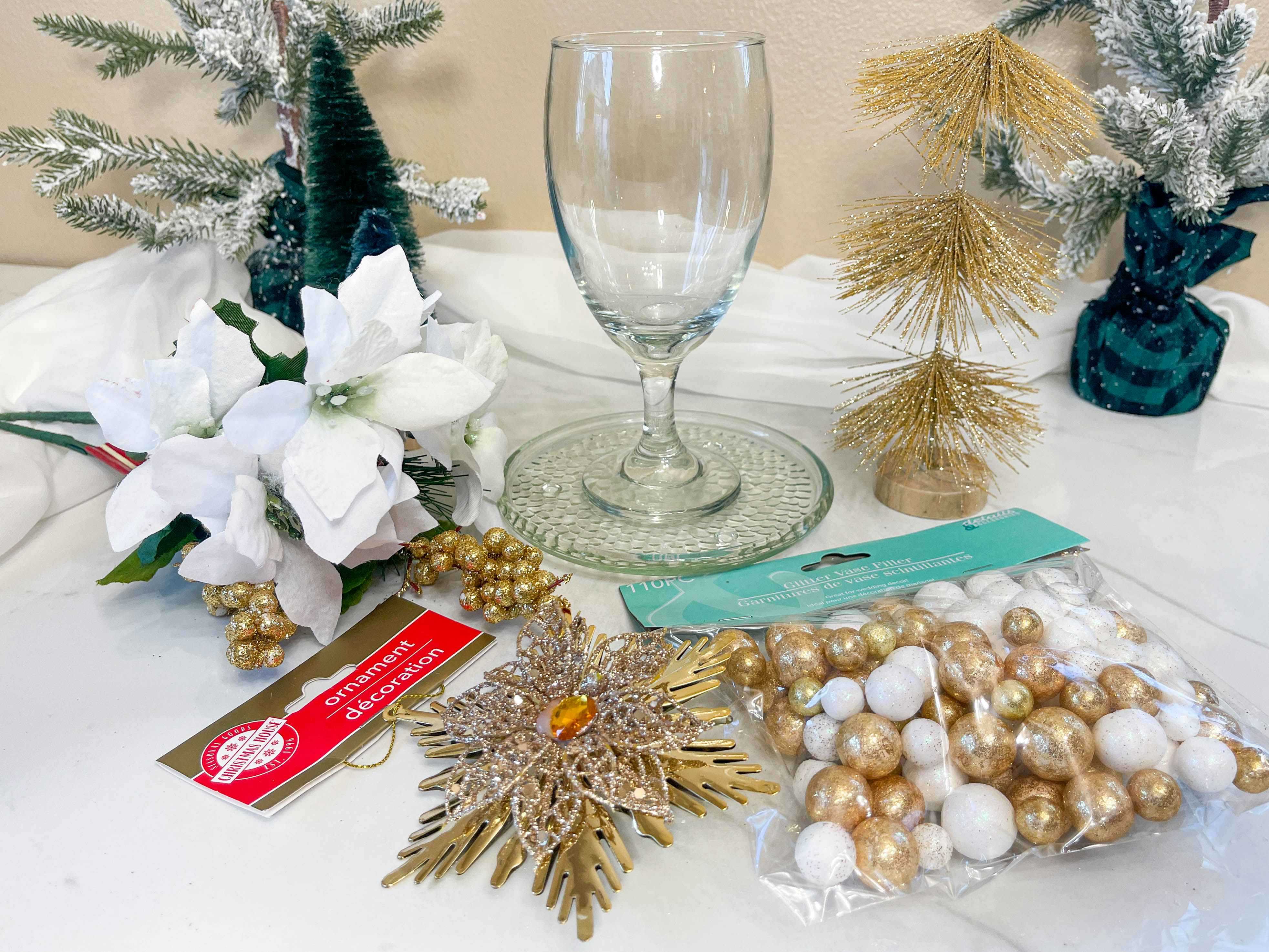 supplies to make a wine glass candle holder on table