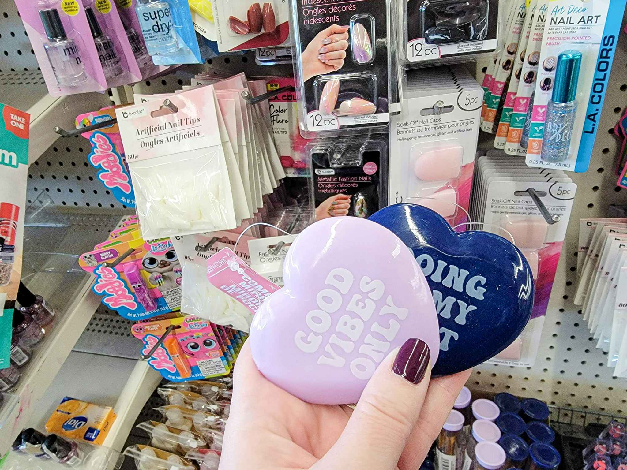 hand holding heart shaped mirrors