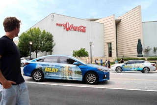 Carvertise cars parked on a road
