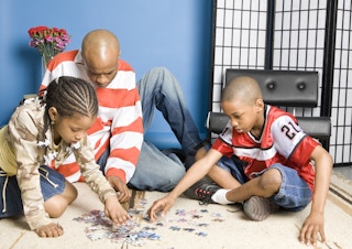 family doing puzzle