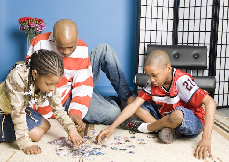 family doing puzzle