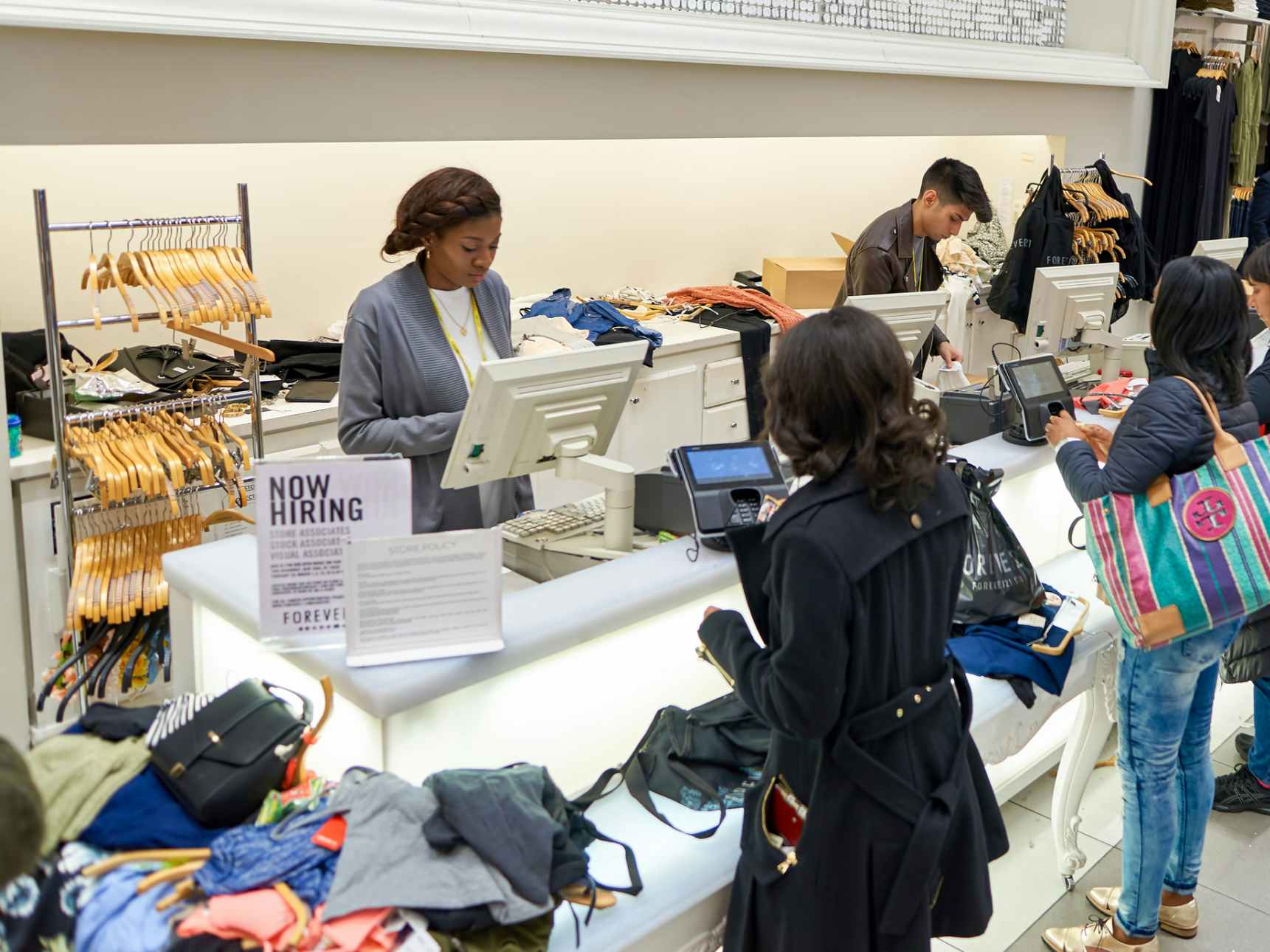 People at the checkout counter inside a Forever 21 store