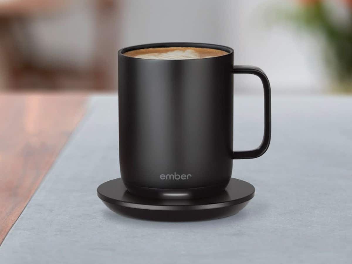 An Ember mug on its charging station with coffee in it