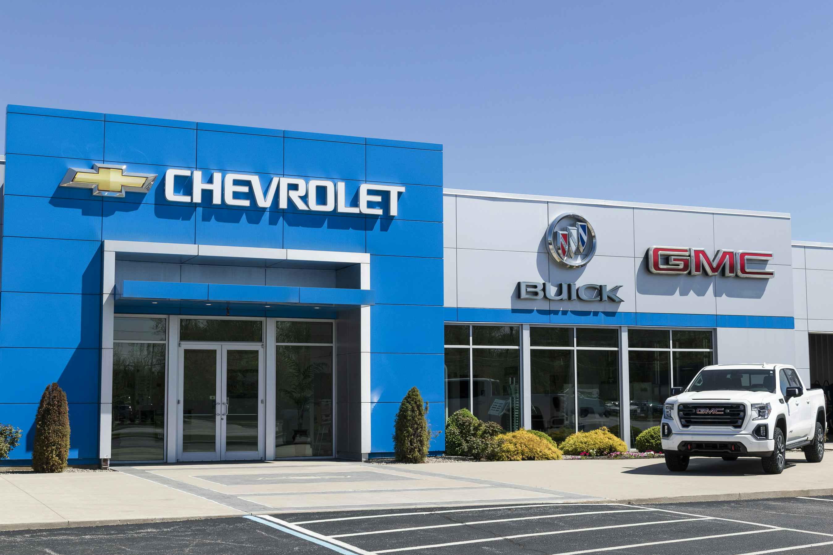 A Chevrolet, Buick, and GMC dealership with a truck parked out front