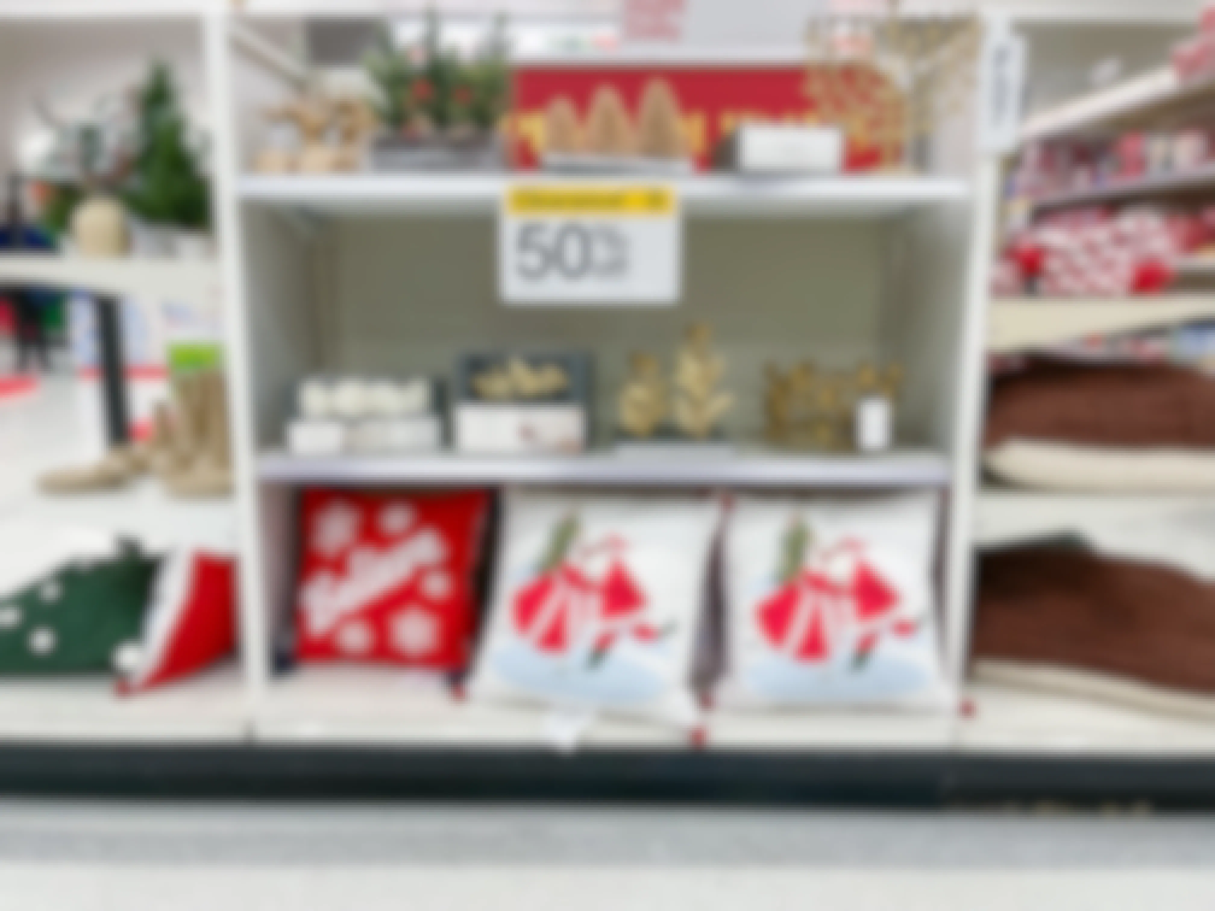 An area shot of clearance items on store shelves with a clearance sign attached to the shelf.