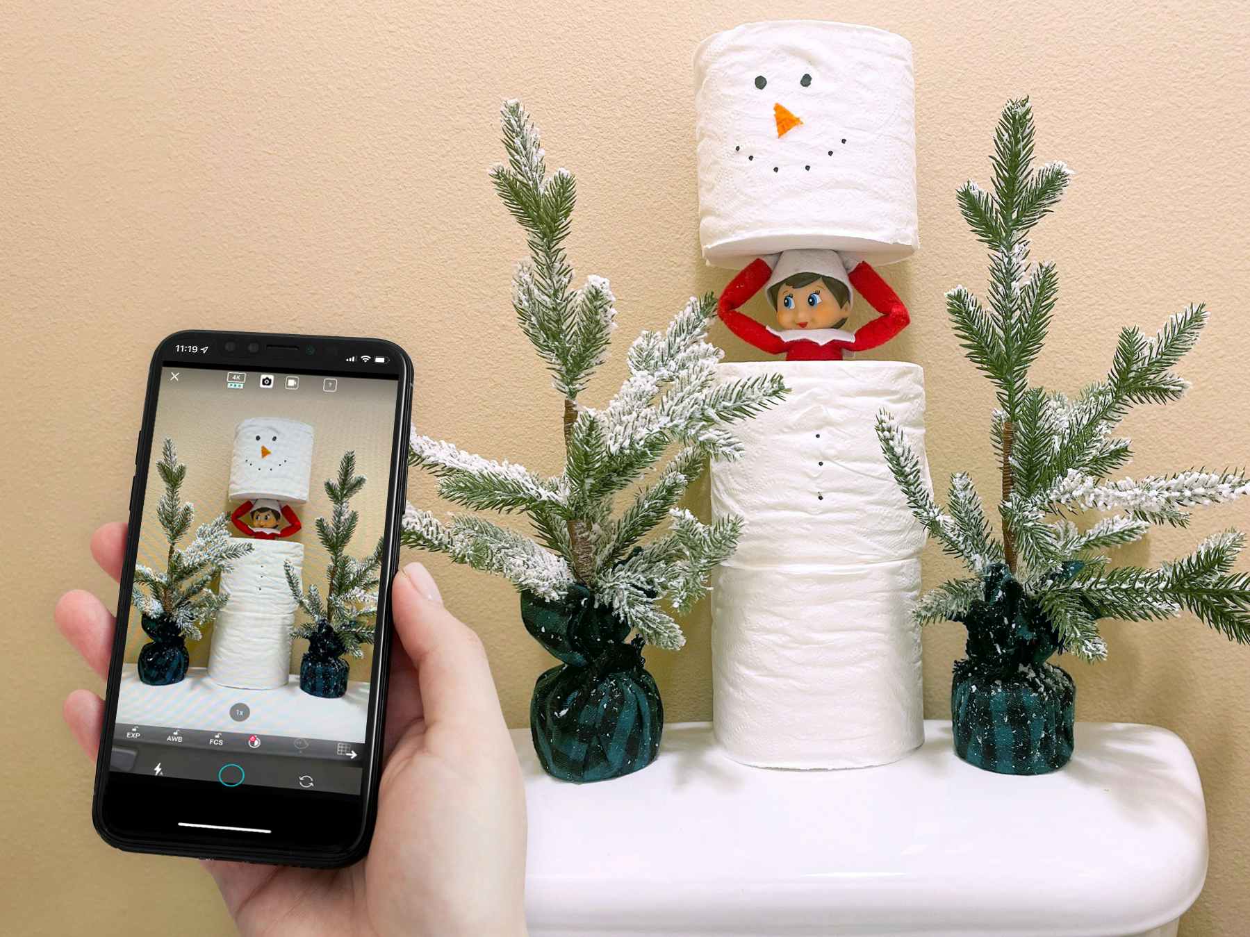 person holding iphone using lifelapse app to move elf on the shelf