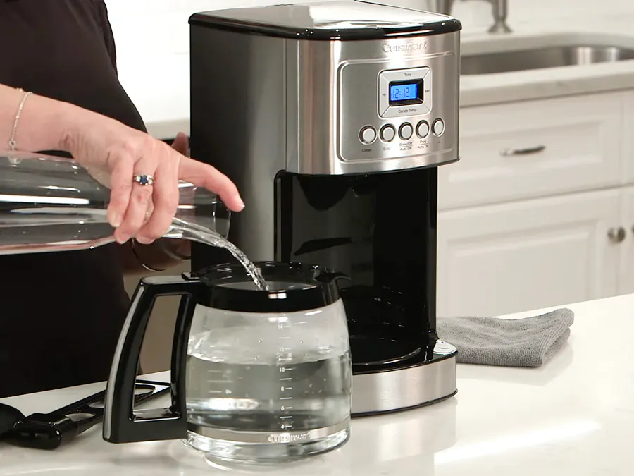 Person cleaning their Cuisinart coffee maker carafe Person cleaning their Cuisinart coffee maker carafe