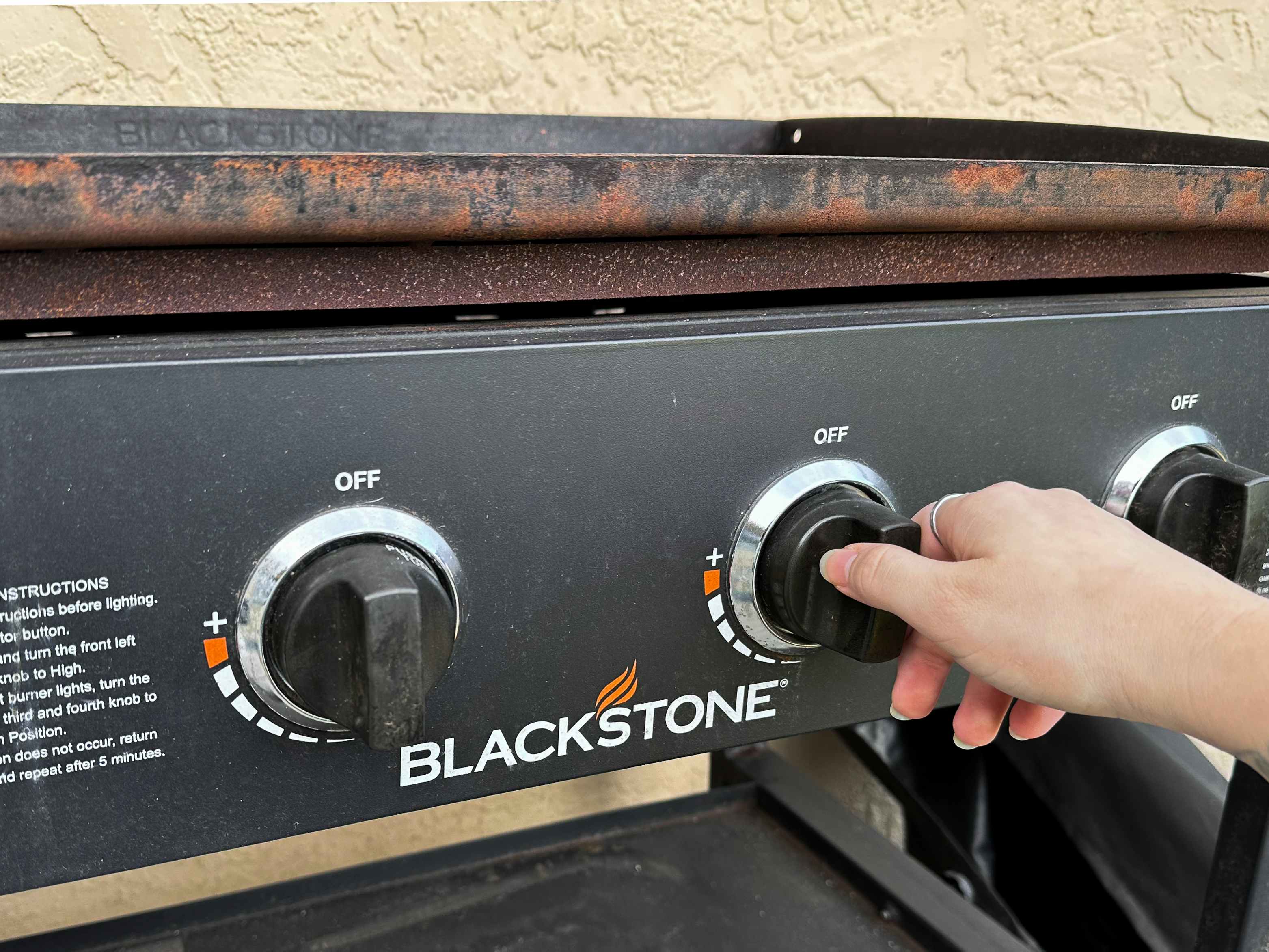 Someone turning on a Blackstone griddle
