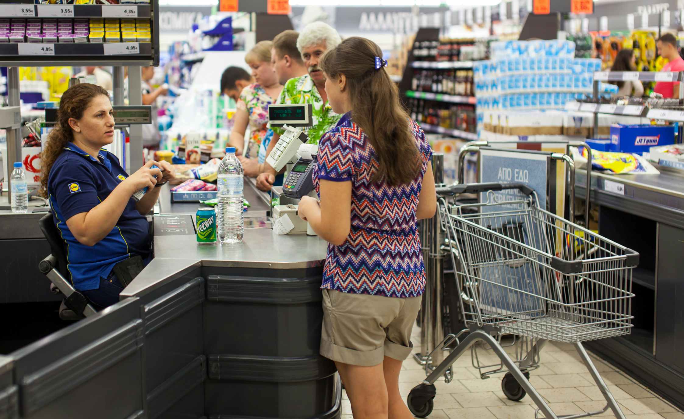 Customers paying for shopping at a supermarket. Line at the cashdesks in the supermarket