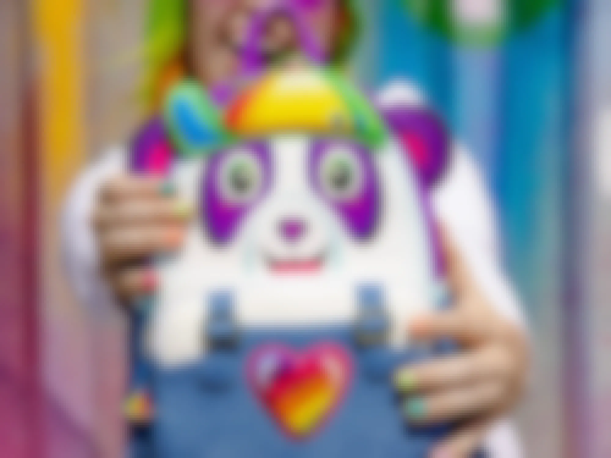 Someone holding up a Lisa Frank Loungefly backpack