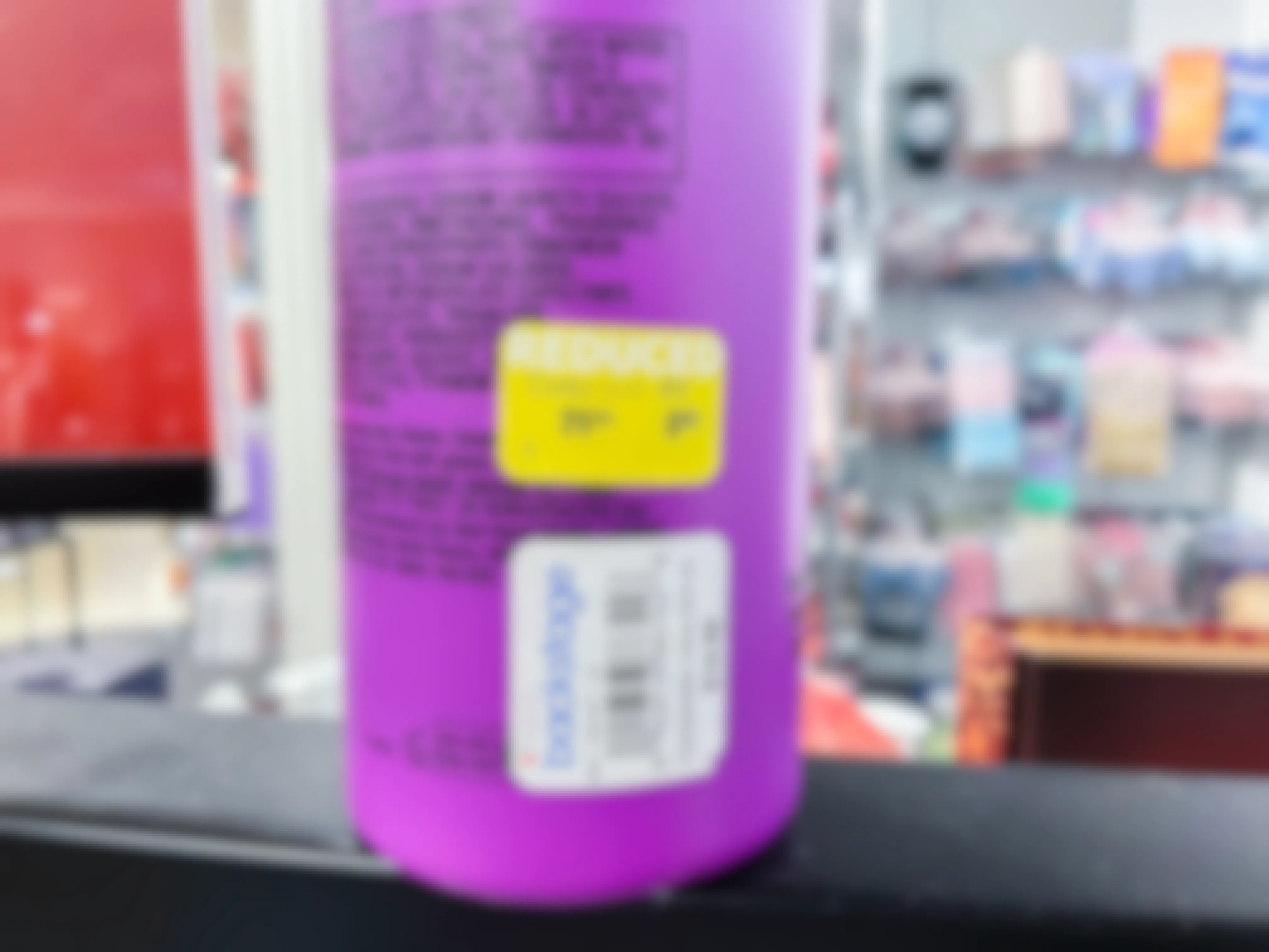a bottle of Bed Head shampoo at Macy's Backstage with a yellow sticker indicating a reduced price