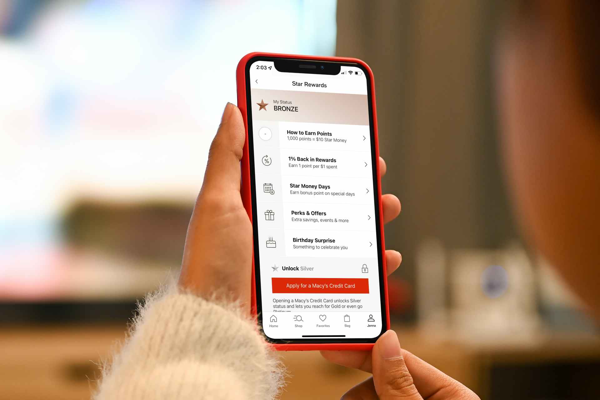 a woman tracking her Macy's Star Rewards on her phone in the Macy's app
