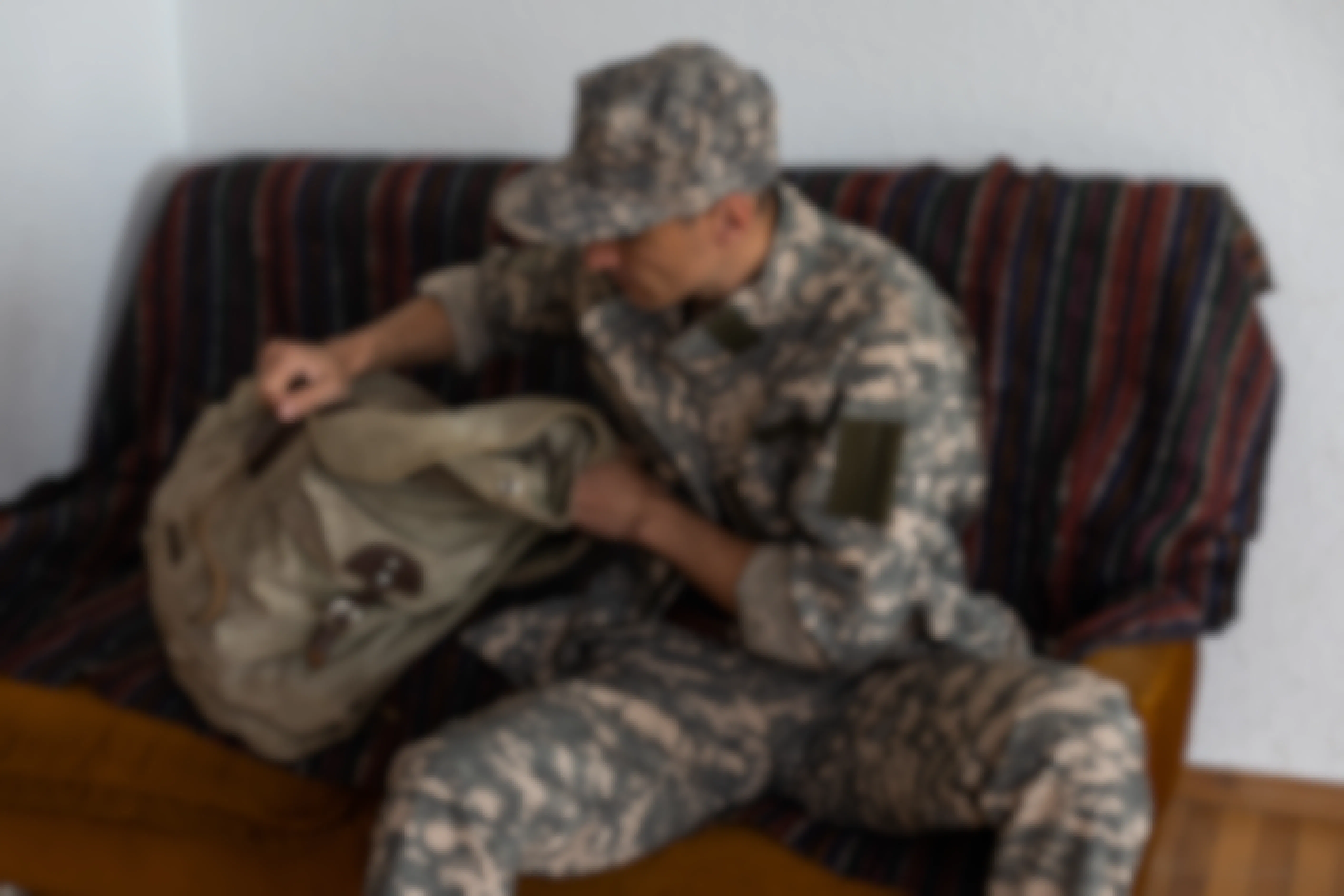 Person packing a bag in a military uniform
