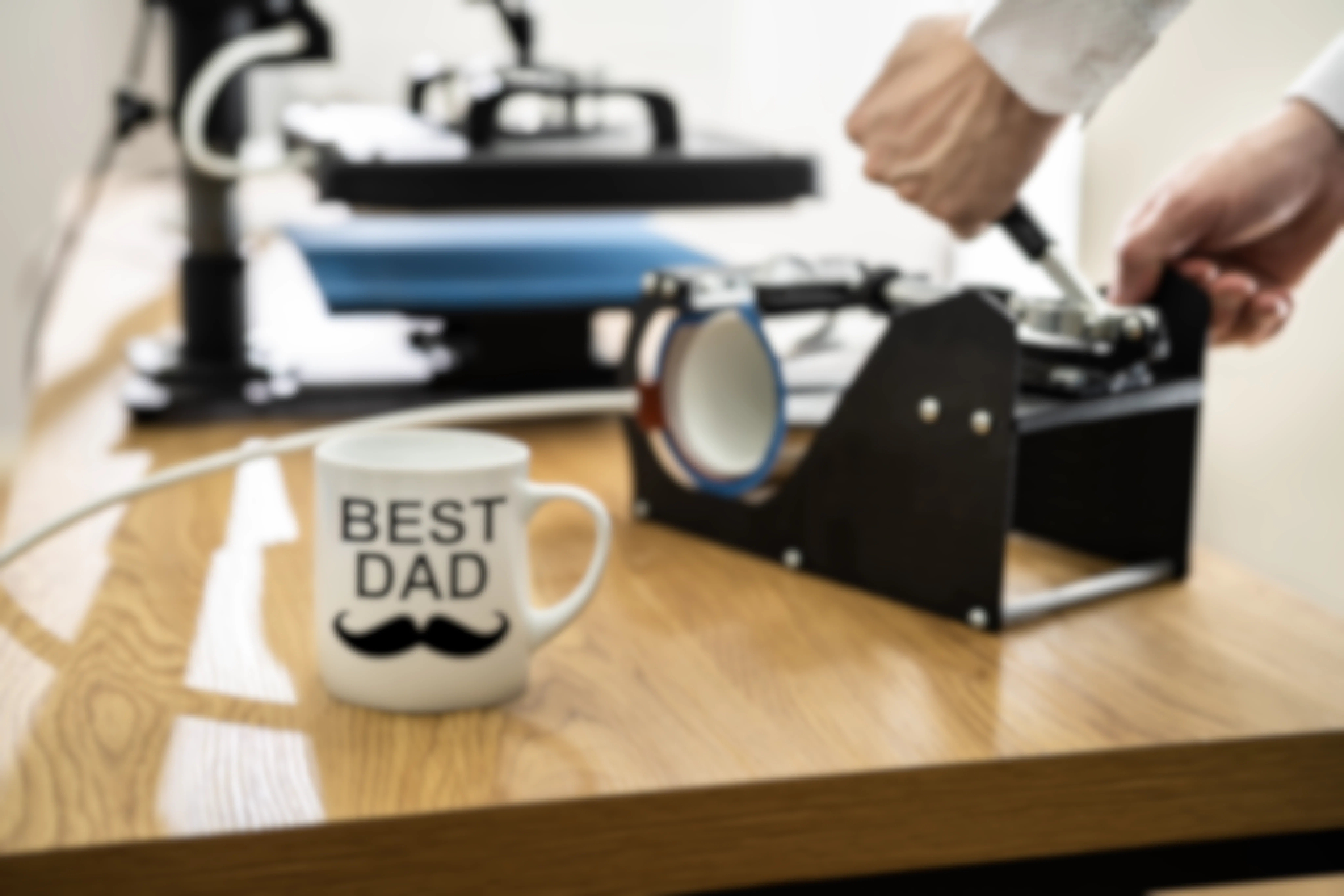 Heat transfer press with mug that says : best dad" in the fore ground