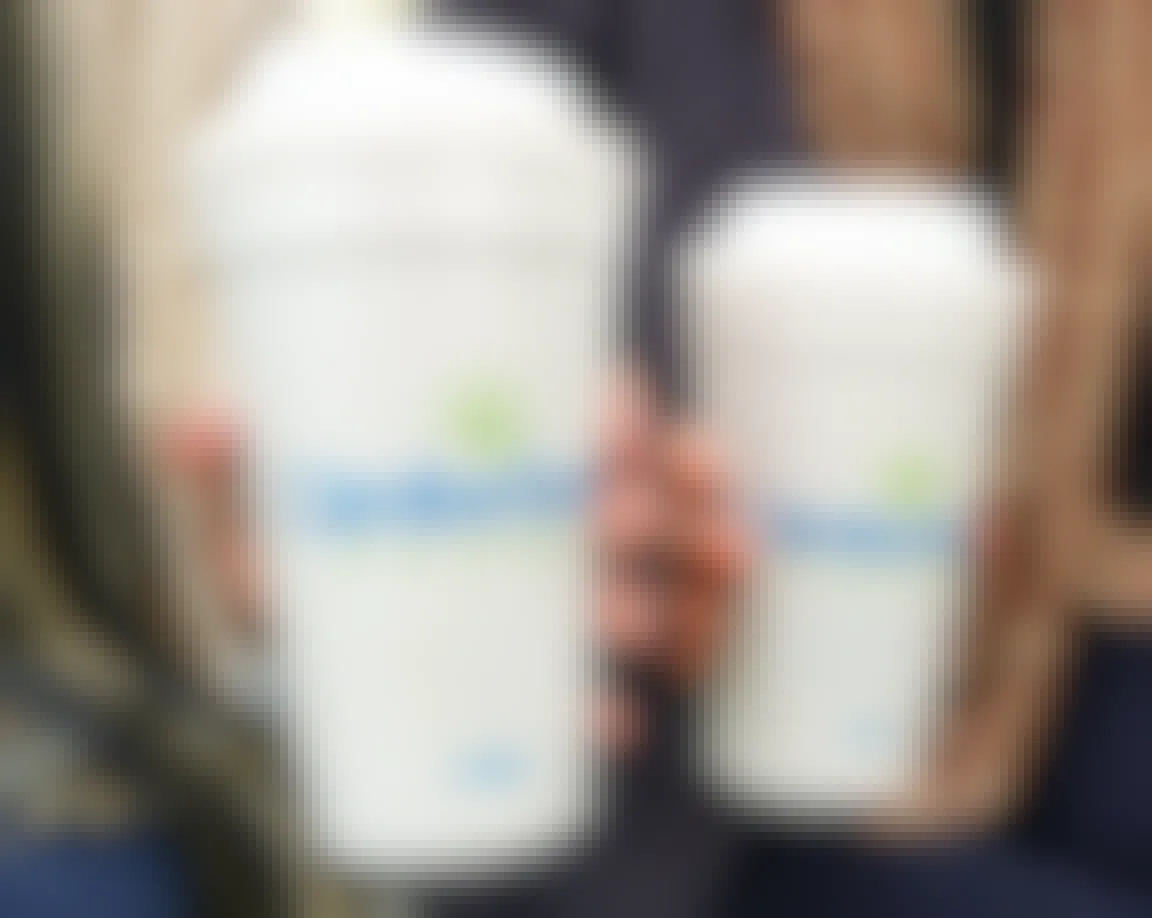 two people holding cumberland coffee cups